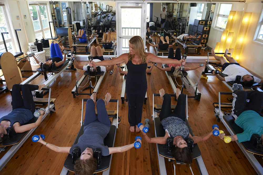 Liz Millard leading a reformer Pilates class in her Mosman studio